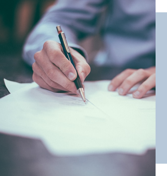 A man is signing a document